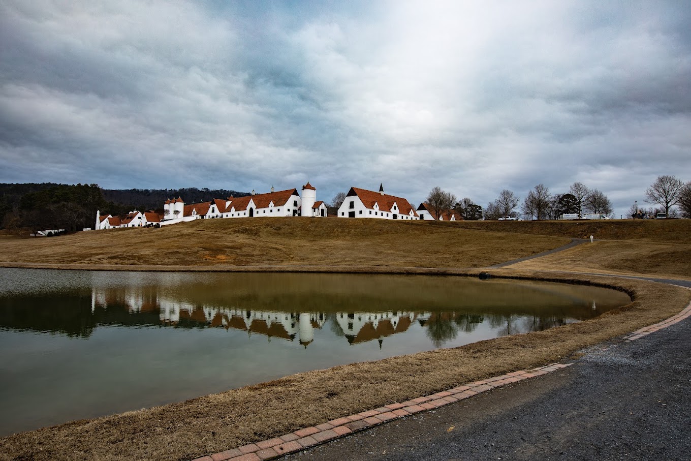 WinShape retreat campus reflected in a still lake under a wide sky
