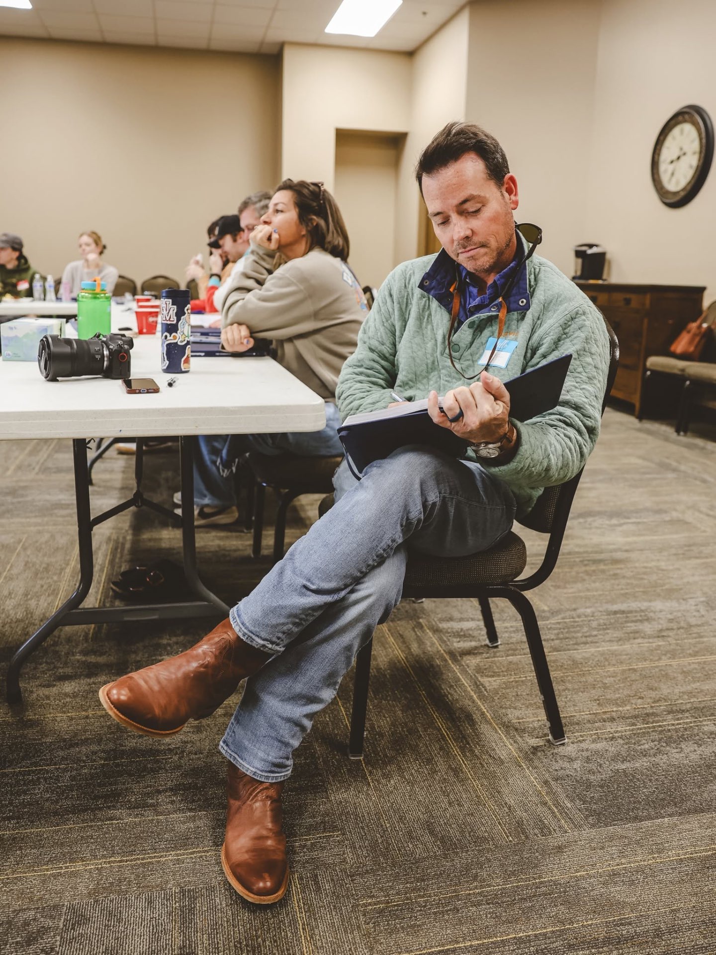 A participant taking notes during a talk