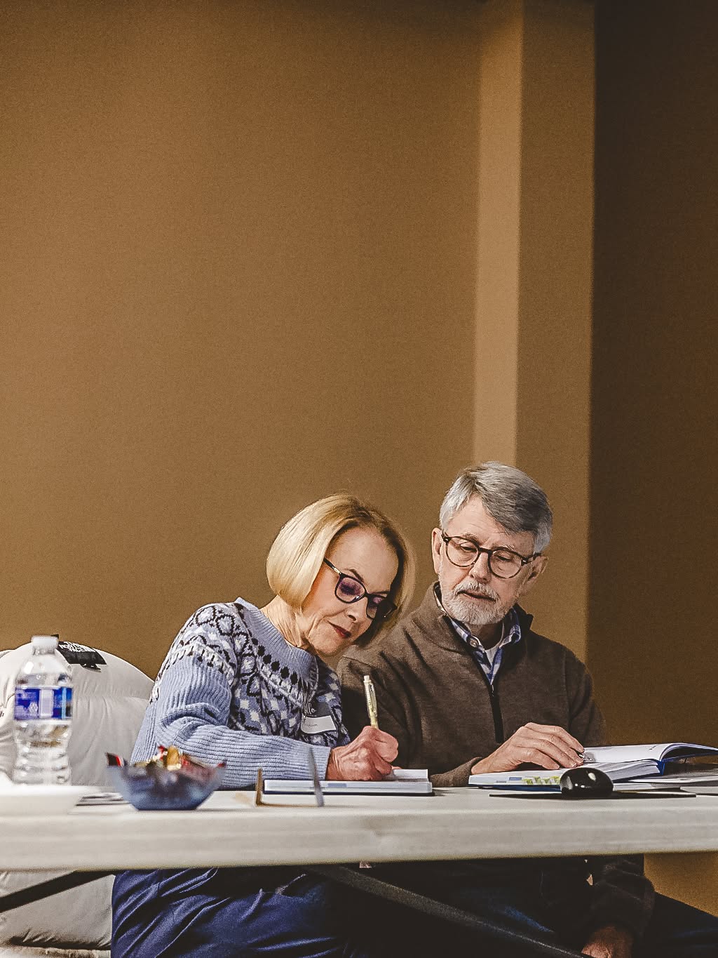 A couple reviewing scripture and study materials